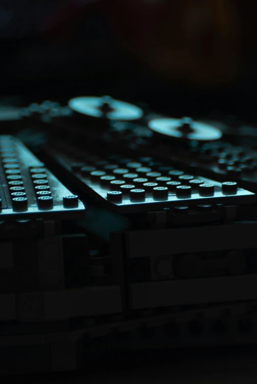 a close up of a keyboard on a table, sci-fi night club, made of lego, experimental studio light, turntables