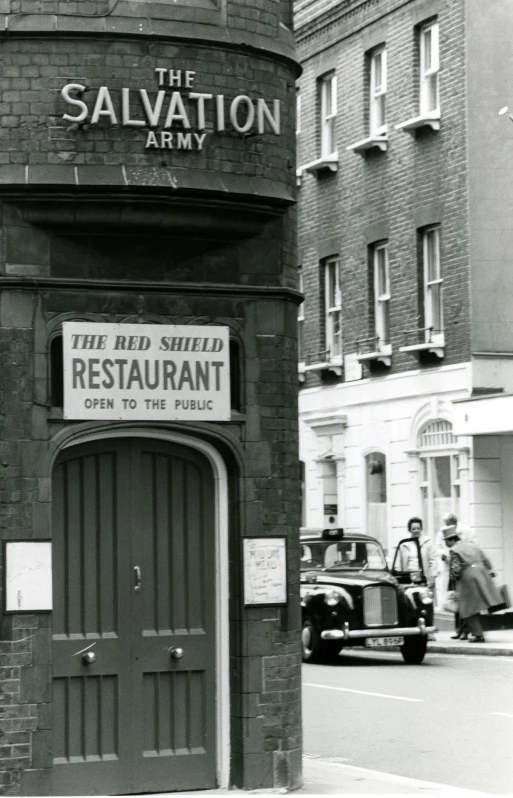 a black and white photo of a restaurant, by Roger Cecil, 'the red citadel, sheild, government archive photograph, street photo