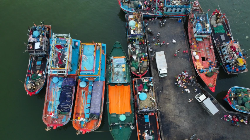 a group of boats sitting on top of a body of water, by Daniel Lieske, pexels contest winner, fish market stalls, hou china, drone footage, thumbnail