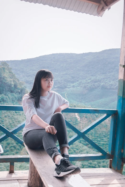 a woman sitting on top of a wooden bench, inspired by Ni Yuanlu, pexels contest winner, sumatraism, overlooking a valley with trees, standing in corner of room, portait photo profile picture, sitting in a crane