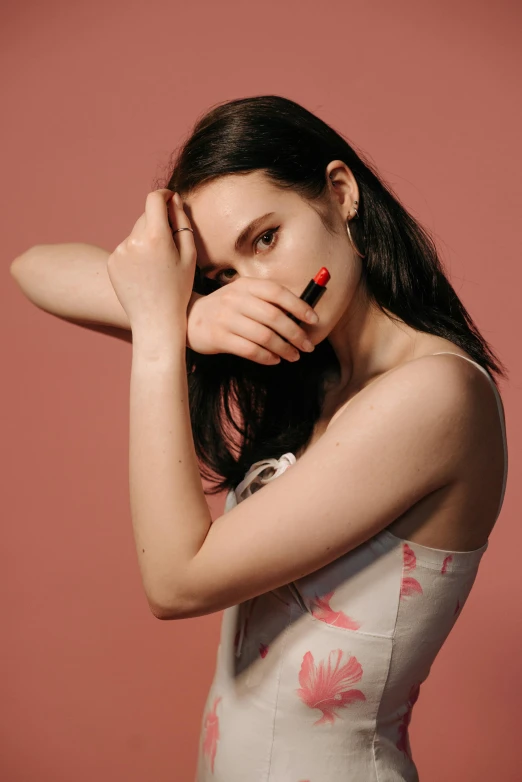 a woman posing with her hands on her face, trending on pexels, pale red, girl with black hair, natali portman, with index finger