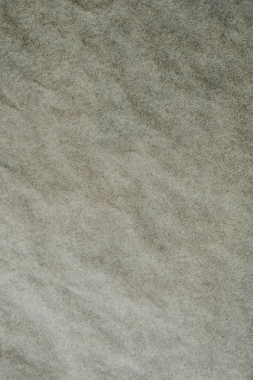 a cat laying on top of a bed next to a pillow, inspired by Cleve Gray, reddit, tonalism, felt!!! texture, texture of sand, detailed product image, light grey
