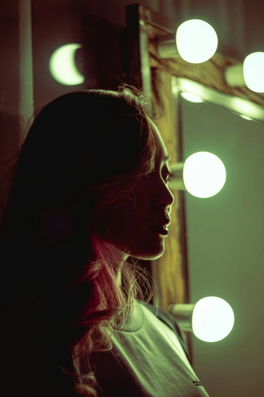 a woman looking at her reflection in a mirror, inspired by Nan Goldin, pexels contest winner, happening, portrait of vanessa morgan, light lighting side view, concert, grainy film still