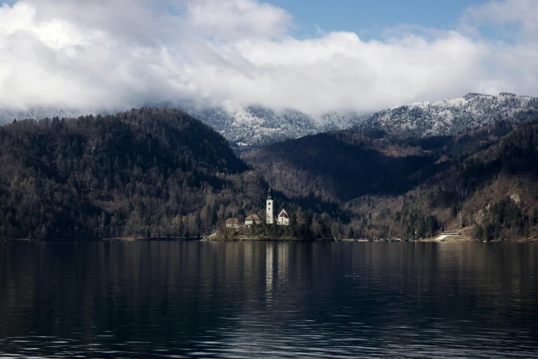 a large body of water with mountains in the background, by Sebastian Spreng, pexels contest winner, renaissance, with snow on its peak, bogna gawrońska, promo image, multiple stories