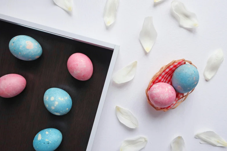 a basket filled with easter eggs sitting on top of a table, blue and pink colour splash, all marble, full product shot, polka dot