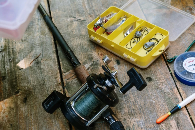 a fishing rod sitting on top of a wooden table, various items, feature, thumbnail, maintenance