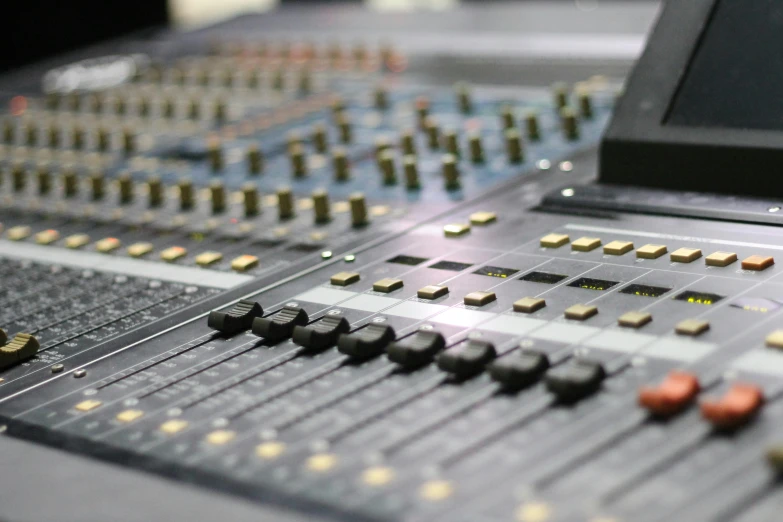 a laptop computer sitting on top of a mixing desk, by David Simpson, pexels, integrated circuit, panels, tuned to a dead channel, the console is tall and imposing