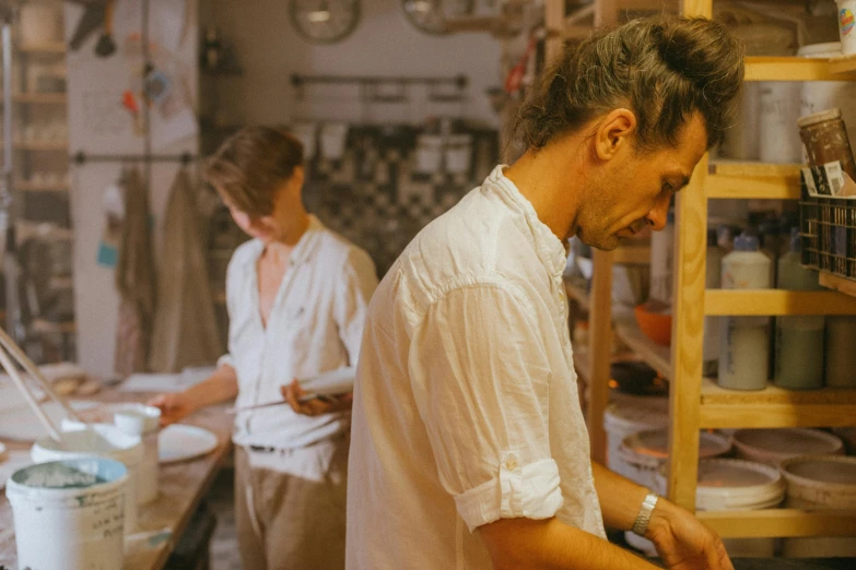 a couple of men standing next to each other in a kitchen, pexels contest winner, process art, hard clay, people at work, profile image