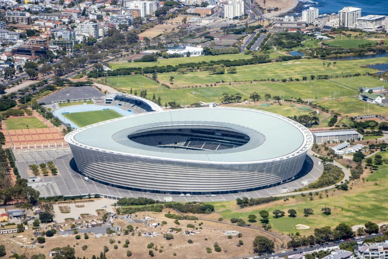 an aerial view of a soccer stadium, inspired by Joze Ciuha, pexels contest winner, zaha hadid building, south african coast, monumental giant palace, 🚿🗝📝