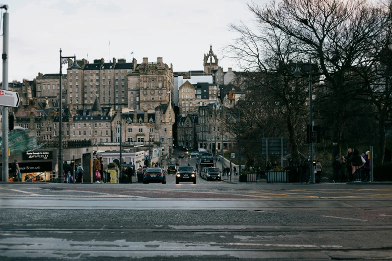 a city street filled with lots of tall buildings, inspired by Thomas Struth, pexels contest winner, art nouveau, edinburgh castle, a cozy, people waiting in bus stop, square