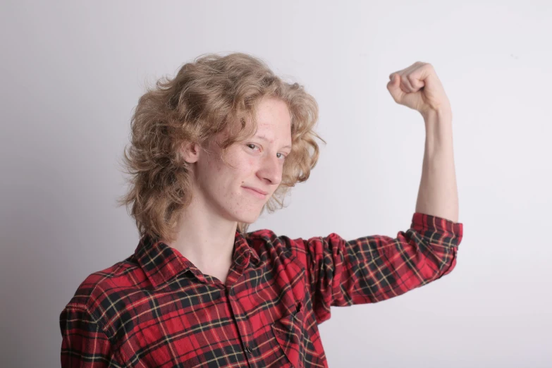 a woman in a plaid shirt posing for a picture, an album cover, pexels, showing off his muscles, pale skin curly blond hair, linus from linustechtips, istockphoto