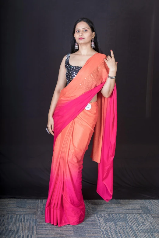 a woman in an orange and pink sari, an album cover, inspired by T. K. Padmini, hurufiyya, fashion shoot 8k, image