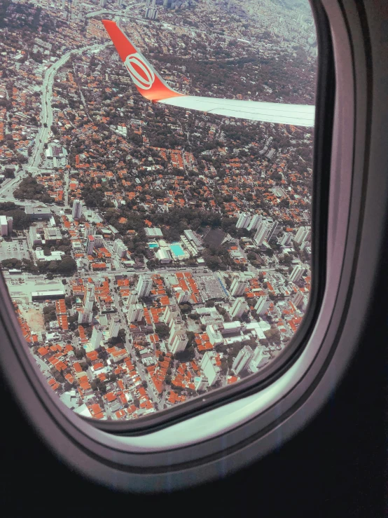 a view of a city from an airplane window, a picture, by Lucia Peka, happening, orange roof, 🤬 🤮 💕 🎀, sports photo, historical photo