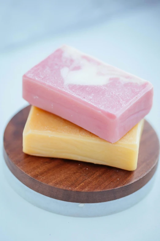 three soap bars stacked on top of each other, by Jessie Algie, on a wooden tray, smooth pink skin, mango, chiffon