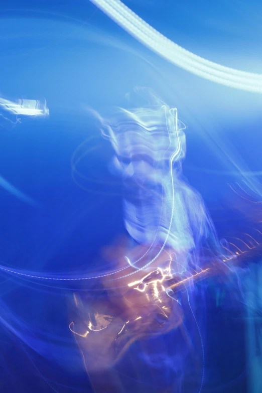 a blurry photo of a man playing a guitar, by Doug Ohlson, lyrical abstraction, dramatic blue light, full frame image, light art, neon ligh
