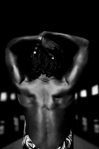a black and white photo of a man with his back to the camera, inspired by Robert Mapplethorpe, flickr, african american woman, dark taint :: athletic, made of flesh and muscles, hands in her hair