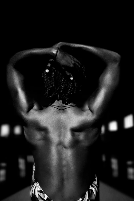 a black and white photo of a man with his back to the camera, inspired by Robert Mapplethorpe, flickr, african american woman, dark taint :: athletic, made of flesh and muscles, hands in her hair