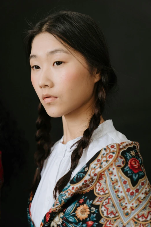 a woman standing in front of a black background, inspired by Kim Tschang Yeul, trending on pexels, cloisonnism, loose white braid, portrait of a japanese teen, high details on clothes, floral details