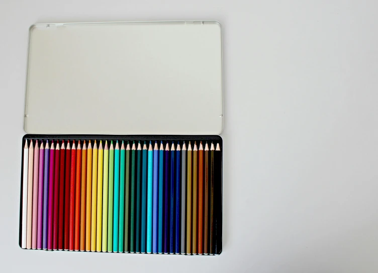 a box of colored pencils sitting on top of a table, a minimalist painting, by Carey Morris, unsplash, black on white background, reflective gradient, 7 0 s palette, fiery coloring