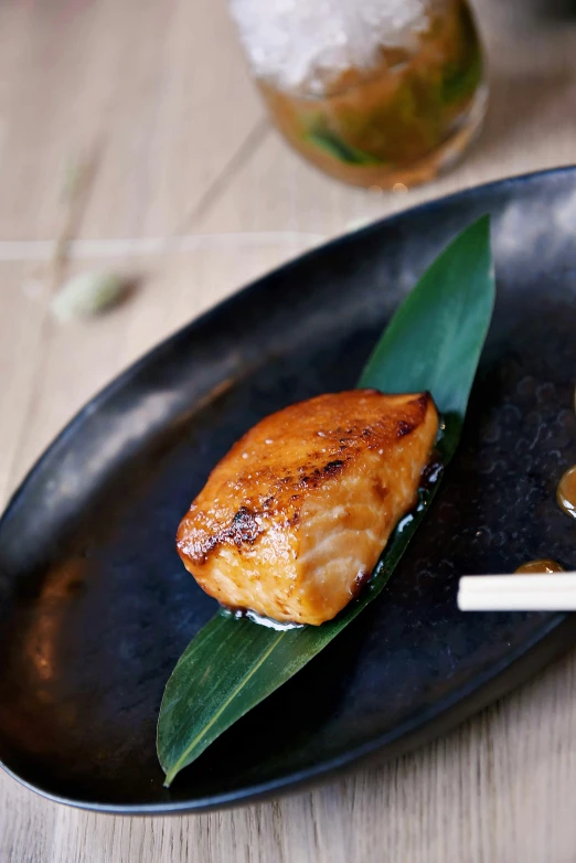 a close up of a plate of food on a table, a picture, inspired by Kanō Naizen, fish tail, caramel, thumbnail, bamboo