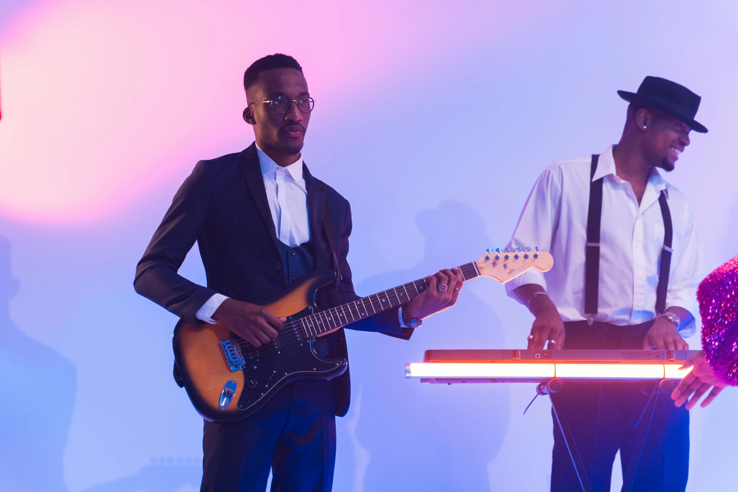 a couple of men standing next to each other holding guitars, pexels contest winner, figuration libre, keyboardist, mkbhd, light from right, performing a music video