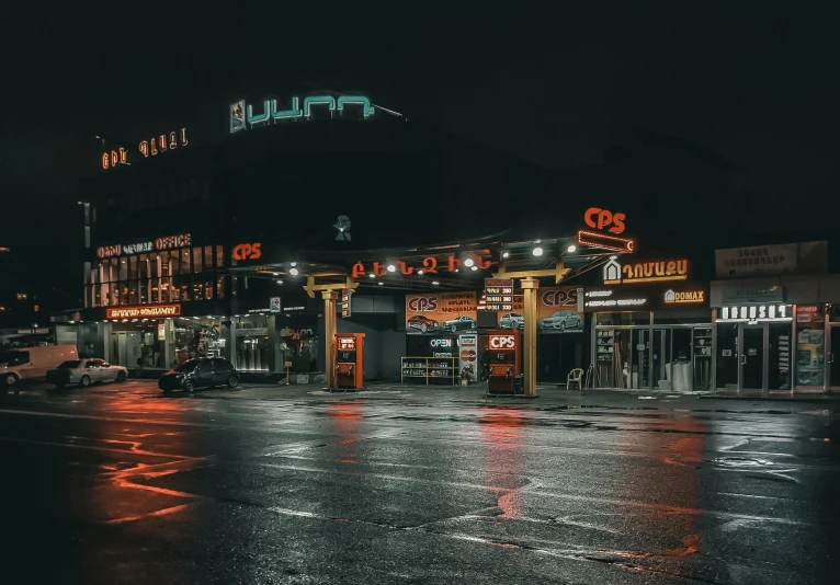 a black and white photo of a city street at night, by Micha Klein, pexels contest winner, colorful neon signs, gas station, orange lights, hannover
