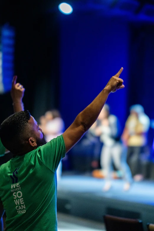 a group of people standing on top of a stage, trending on unsplash, happening, indistinct man with his hand up, scene from church, dabbing, photo taken in 2018