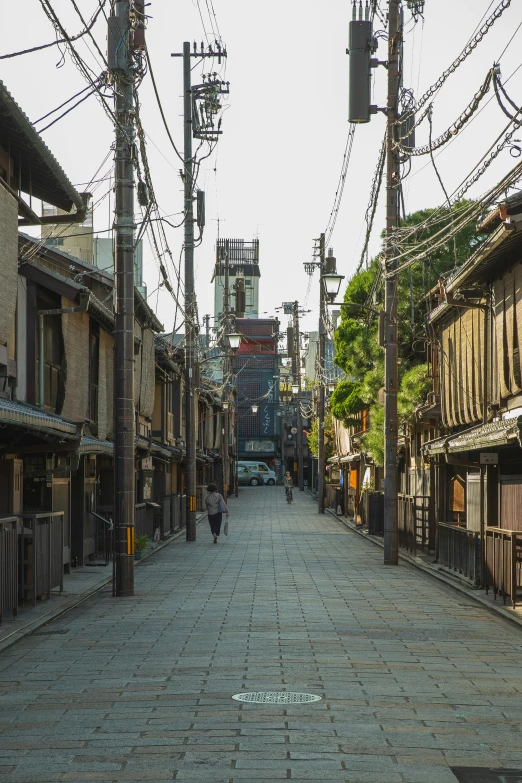 a narrow street lined with wooden buildings, inspired by Takeuchi Seihō, unsplash, sōsaku hanga, in a massive cavernous iron city, calm afternoon, ruins around, single street