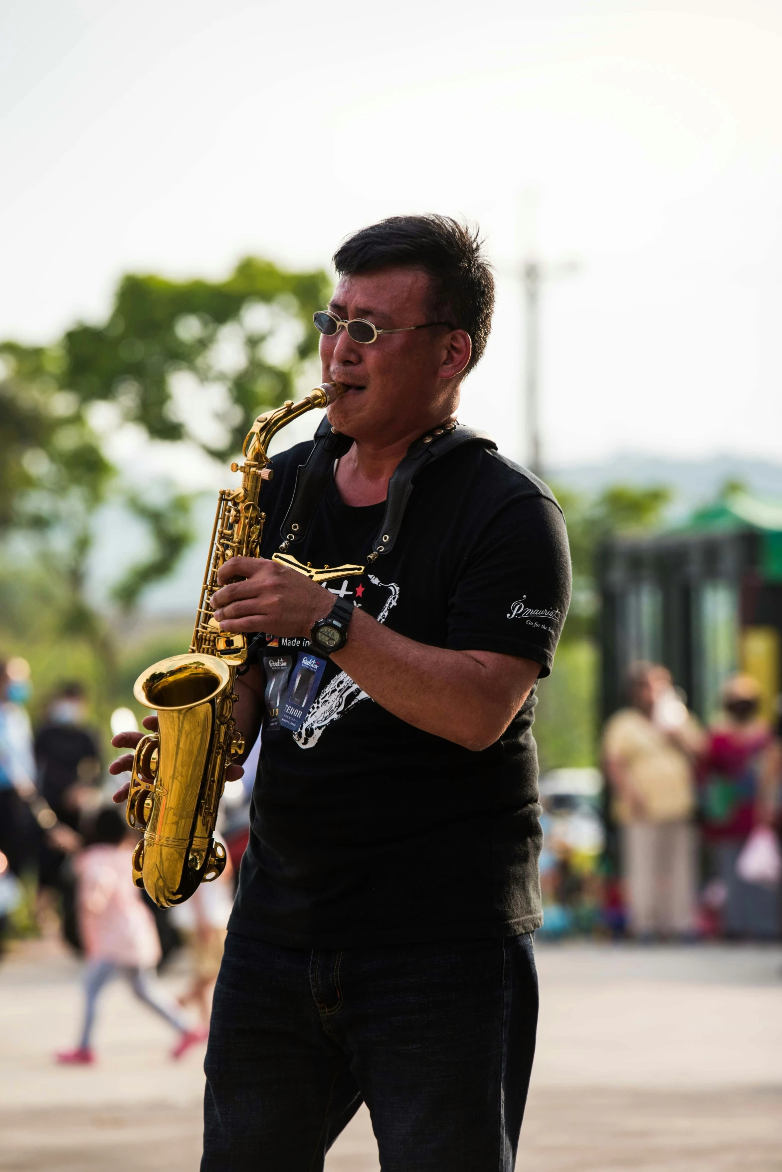 a man in a black shirt playing a saxophone, by Simon Gaon, pexels contest winner, happening, yellow dragon head festival, square, low quality photo, 🚿🗝📝