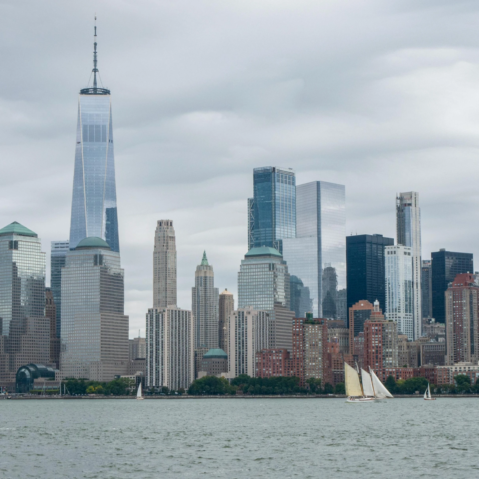 a sailboat in a body of water with a city in the background, modern new york, 4k photo”, full frame image, 2 0 2 2 photo