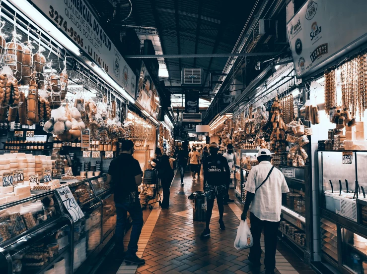 a group of people walking through a grocery store, by Julia Pishtar, pexels contest winner, wet market street, 🦩🪐🐞👩🏻🦳, nostalgic vibes, spanish