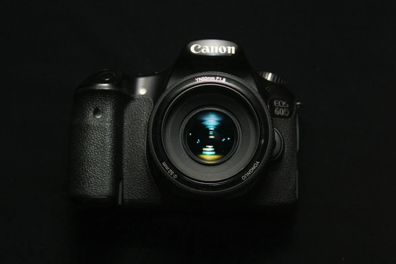 a canon camera sitting on top of a black table, canon eos 6d, digital camera, low - light photography, macro lens