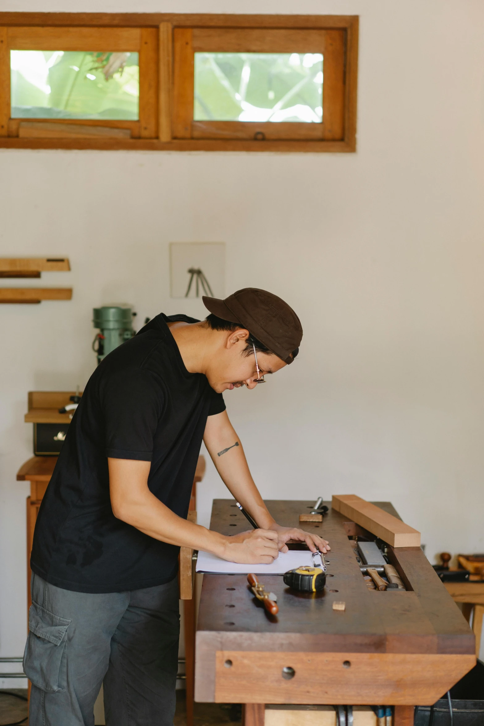 a man working on a piece of wood in a workshop, a drawing, inspired by Ruth Jên, pexels contest winner, signing a bill, julian ope, profile image, full body image