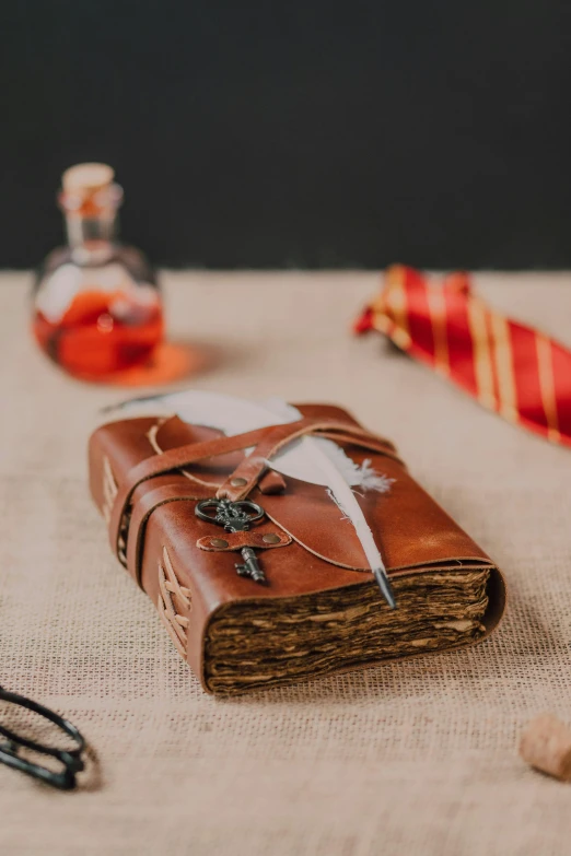 a book sitting on top of a table next to a pair of scissors, inspired by Hermione Hammond, renaissance, cosplay journal cover, medium-shot, studio shot, flasks