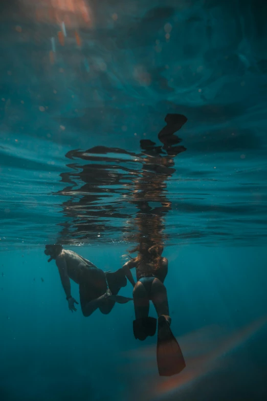 a couple of people that are in the water, a picture, by Jessie Algie, unsplash contest winner, descend into the deep, shade, maintenance, uncropped