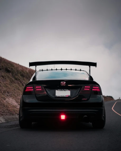 a car that is sitting on the side of a road, by Jeffrey Smith, unsplash, tail lights, honda civic, full body backlight, low quality photo