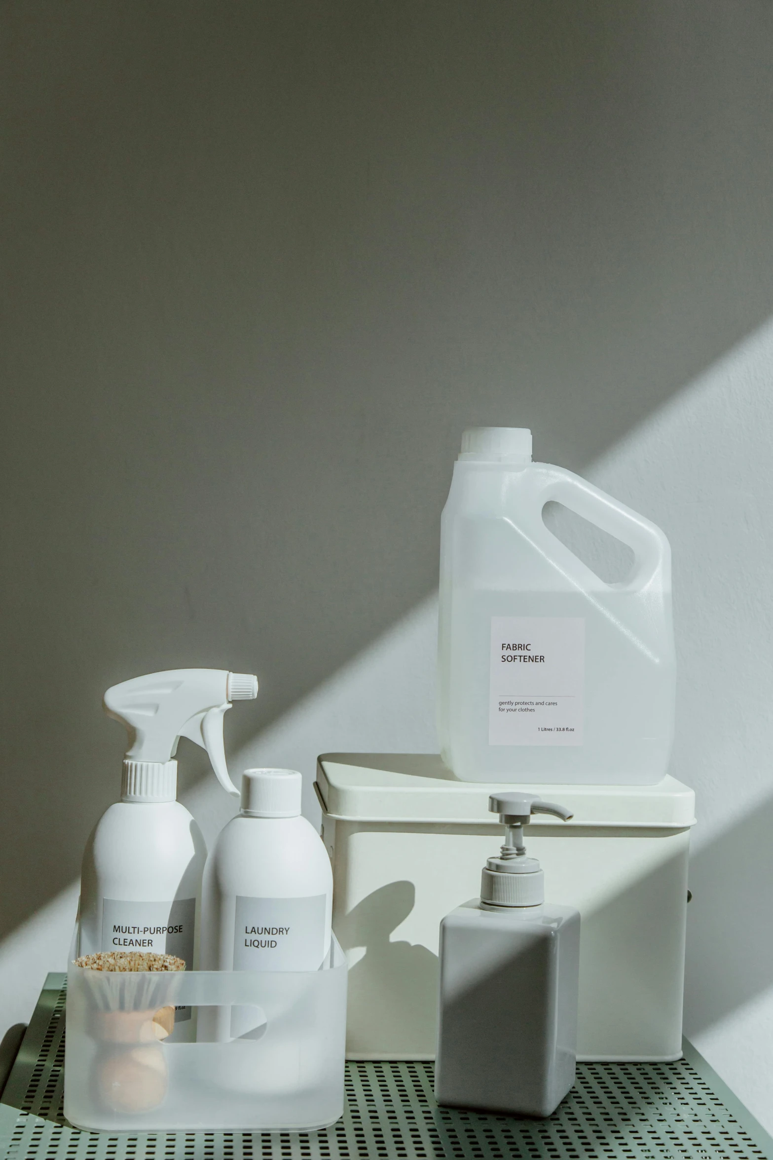 a couple of bottles sitting on top of a table, in white room, utility, product display, spray