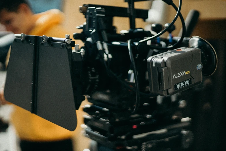 a close up of a camera on a tripod, by Adam Rex, shot on arri alexa, with back to the camera, alexa grace, b - roll