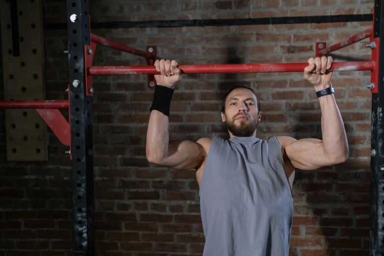 a man is doing pull ups in a gym, a portrait, featured on reddit, avatar image, background image, square, maintenance photo