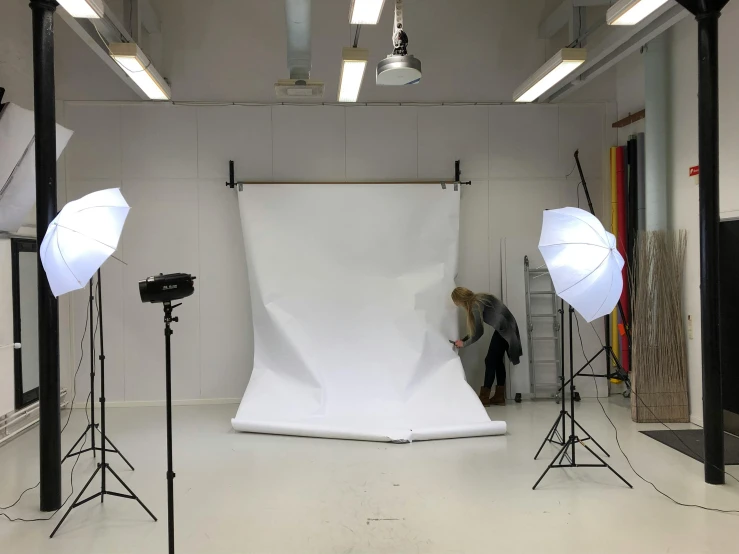 a photo studio with a white backdrop and lighting equipment, by Matthias Stom, unsplash, animation, studio medium format photograph, group photo, editorial footage
