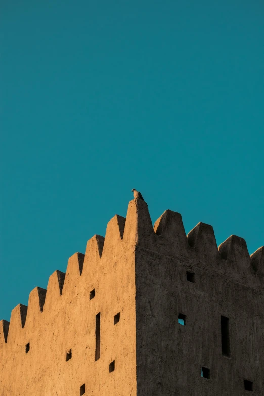 a tall building with a clock on top of it, an album cover, by Ahmed Yacoubi, pexels contest winner, minimalism, medieval arabia, sky blue, castle wall, sharp spines