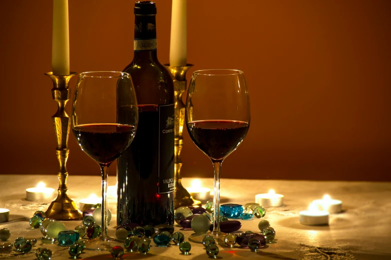 a bottle of wine sitting next to two glasses of wine, a still life, pexels, renaissance, candle lights, profile image, maroon and blue accents, brown