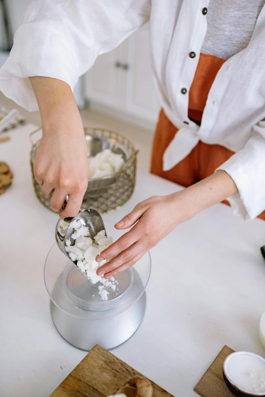 a woman is preparing food in a kitchen, a marble sculpture, trending on pexels, marshmallow, white salt, thumbnail, 4l