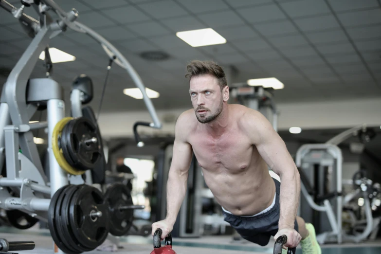 a man doing push ups with kettlebells in a gym, a portrait, by Andries Stock, esthetic photo, image, 8k octan photo, andrzej sykut