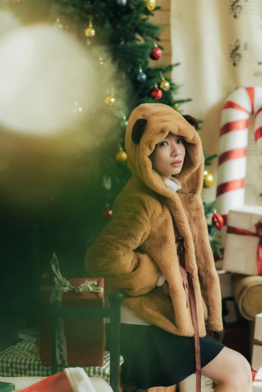 a little girl sitting in front of a christmas tree, pexels, realism, hooded fur coat, korean woman, indoor scene, gif