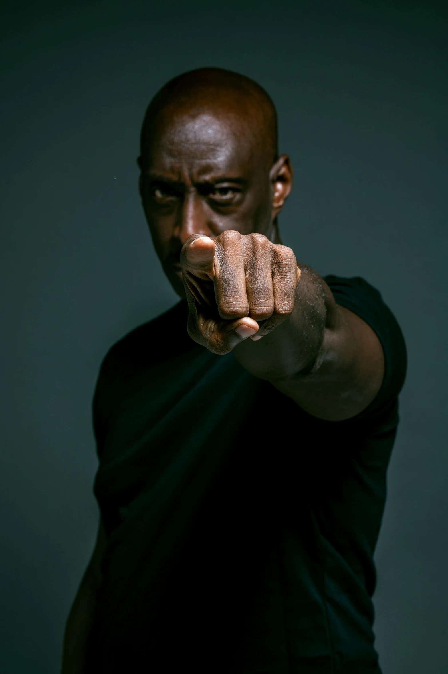 a man pointing his finger at the camera, an album cover, by Dean Ellis, pexels, hyperrealism, lance reddick, in a fighting stance, actors, 15081959 21121991 01012000 4k