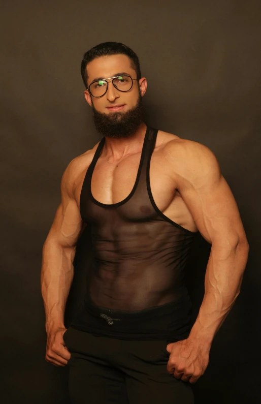 a man with glasses is posing for a picture, an album cover, inspired by Volkan Baga, reddit, black spandex, 30 year old man :: athletic, vests and corsets, see through