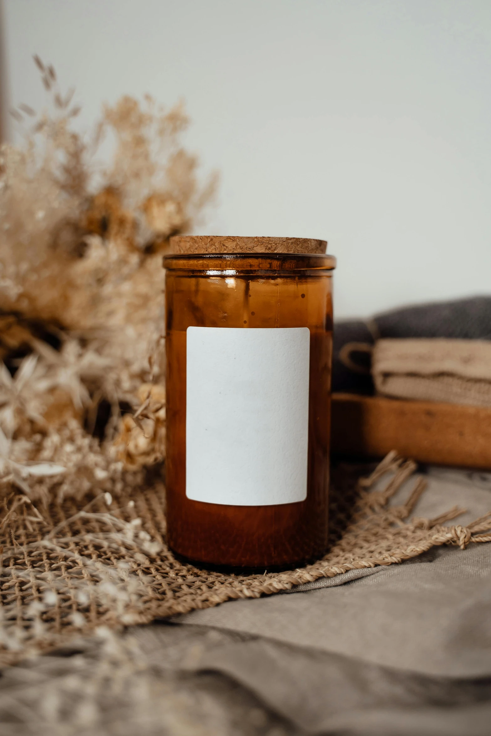 a candle sitting on top of a table next to a book, lots of jars and boxes of herbs, detailed product image, caramel. rugged, thumbnail