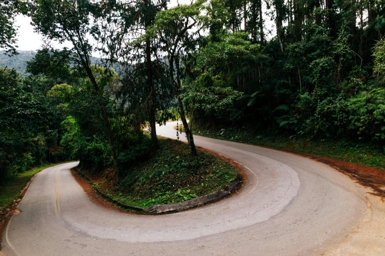 a man riding a skateboard down a curvy road, by Peter Churcher, pexels contest winner, hurufiyya, malaysia jungle, circular shape, panoramic shot, drops around