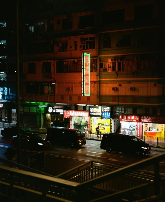 a city street filled with lots of traffic at night, an album cover, inspired by Elsa Bleda, pexels contest winner, hong kong buildings, convenience store, ( colorful ), very dark with green lights